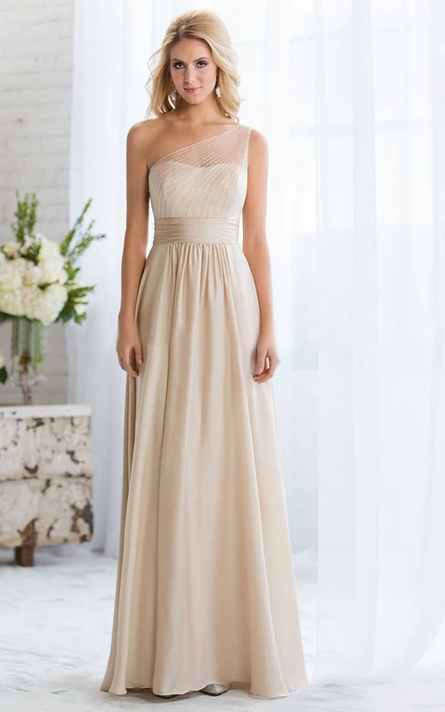 Robe longue asymétrique sans manches, ornée de perles et dotée d'une fermeture éclair.